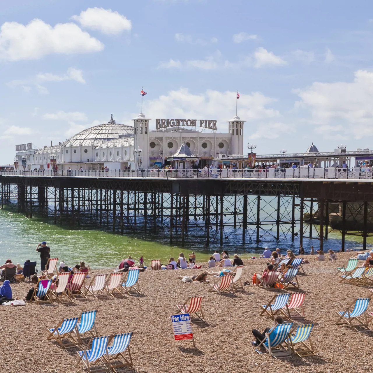 sunny brighton beach in the summer with deck chairs